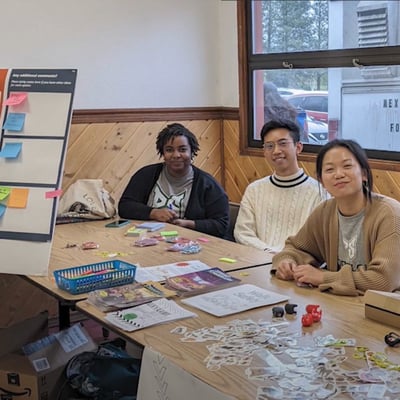MURP students at a table during a community engagement event