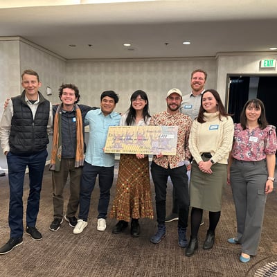 Members of the 2025 PSU ITE Traffic Bowl team pose with an oversized cardboard check.