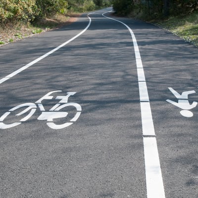 Pavement markings of a bicycle and pedestrian on a path