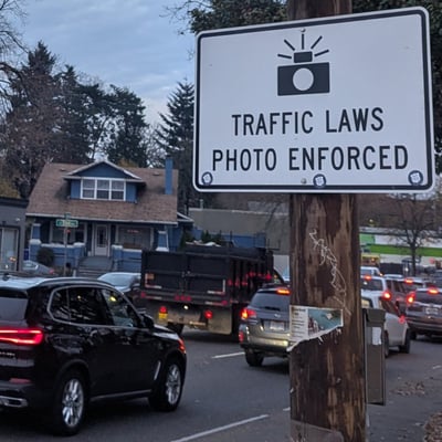 Sign on Portland's Powell Boulevard saying 'Traffic Laws Photo Enforced'